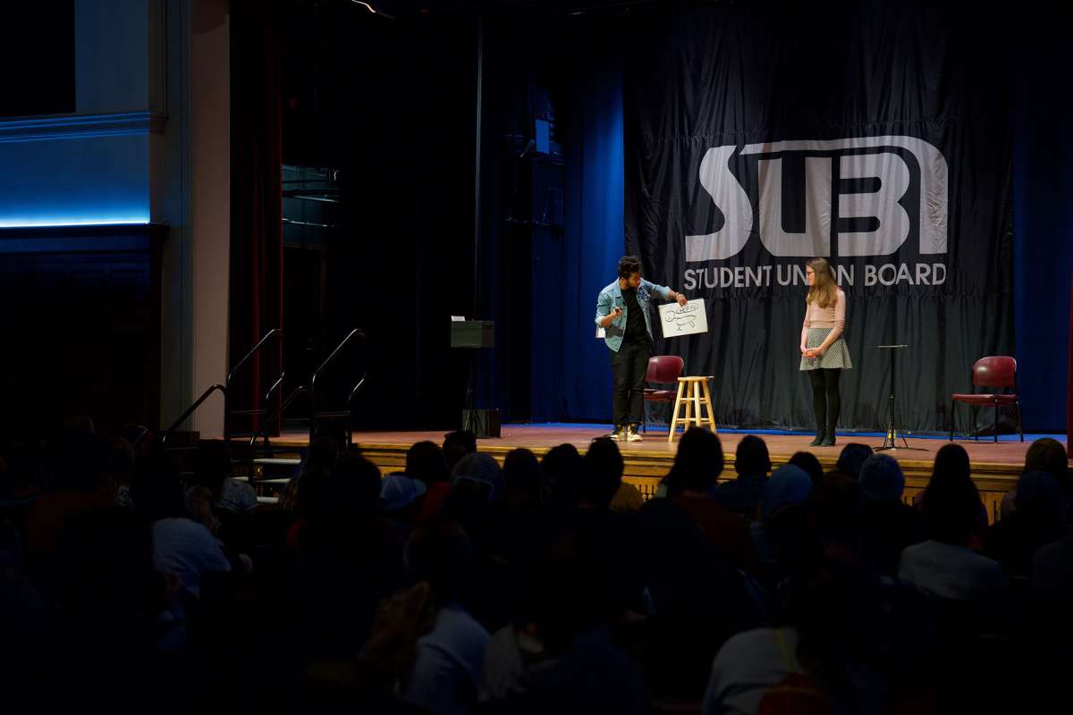 Students watching a performer in the Great Hall